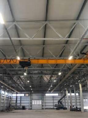 Overhead crane inside industrial building. Bridge crane inside hangar.